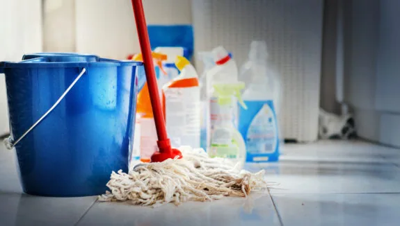 home cleaning products with blue bucket and a mop